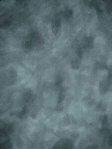 A Grey Color Background With Light White Patches